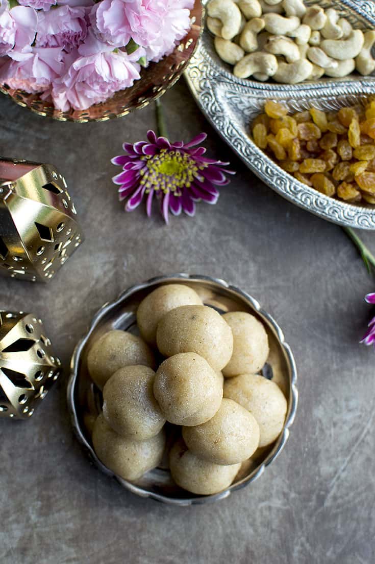 Plate with sooji laddoo and dry fruits around it