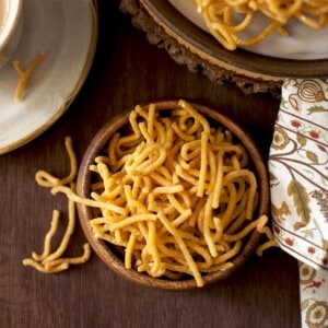 Top view of a wooden bowl filled with besan murukku