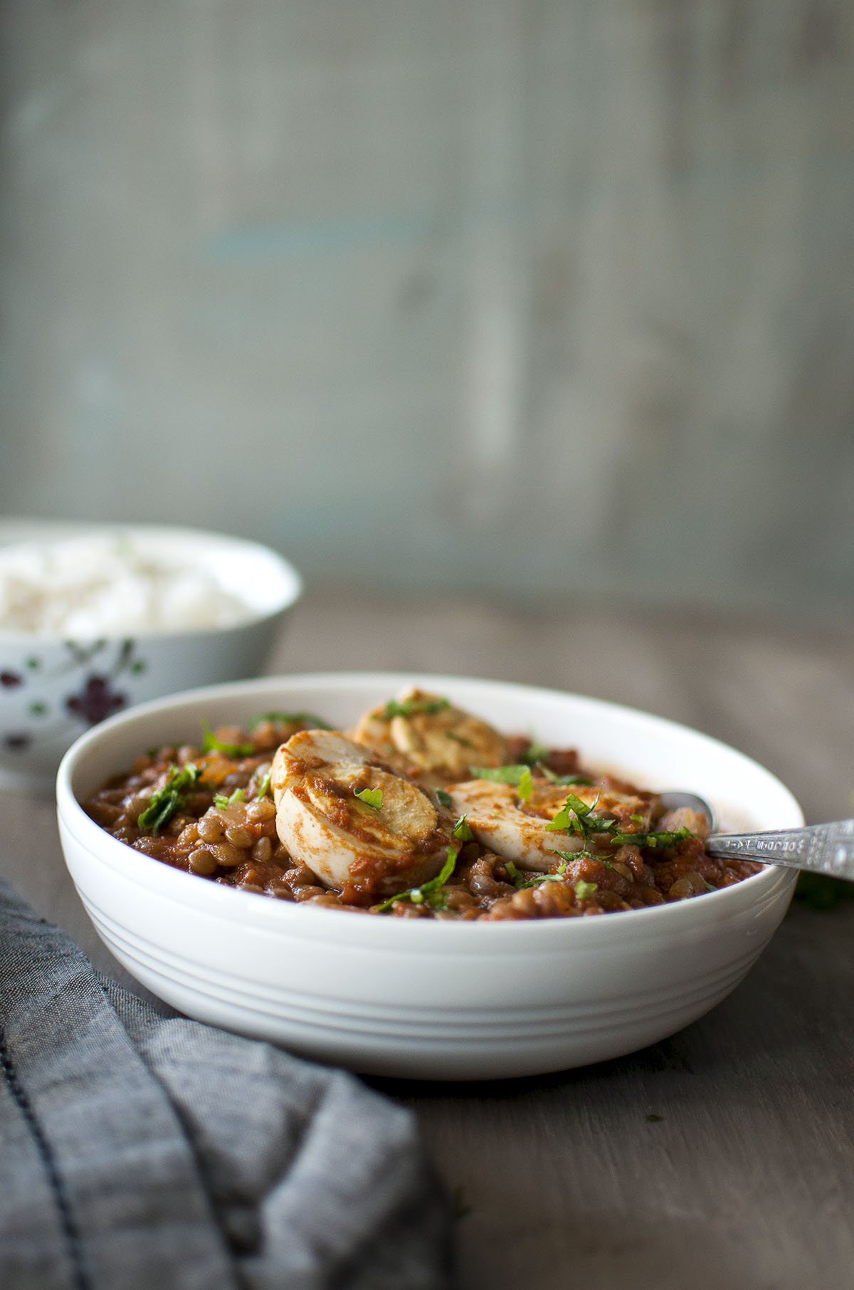 White bowl with egg and lentil curry