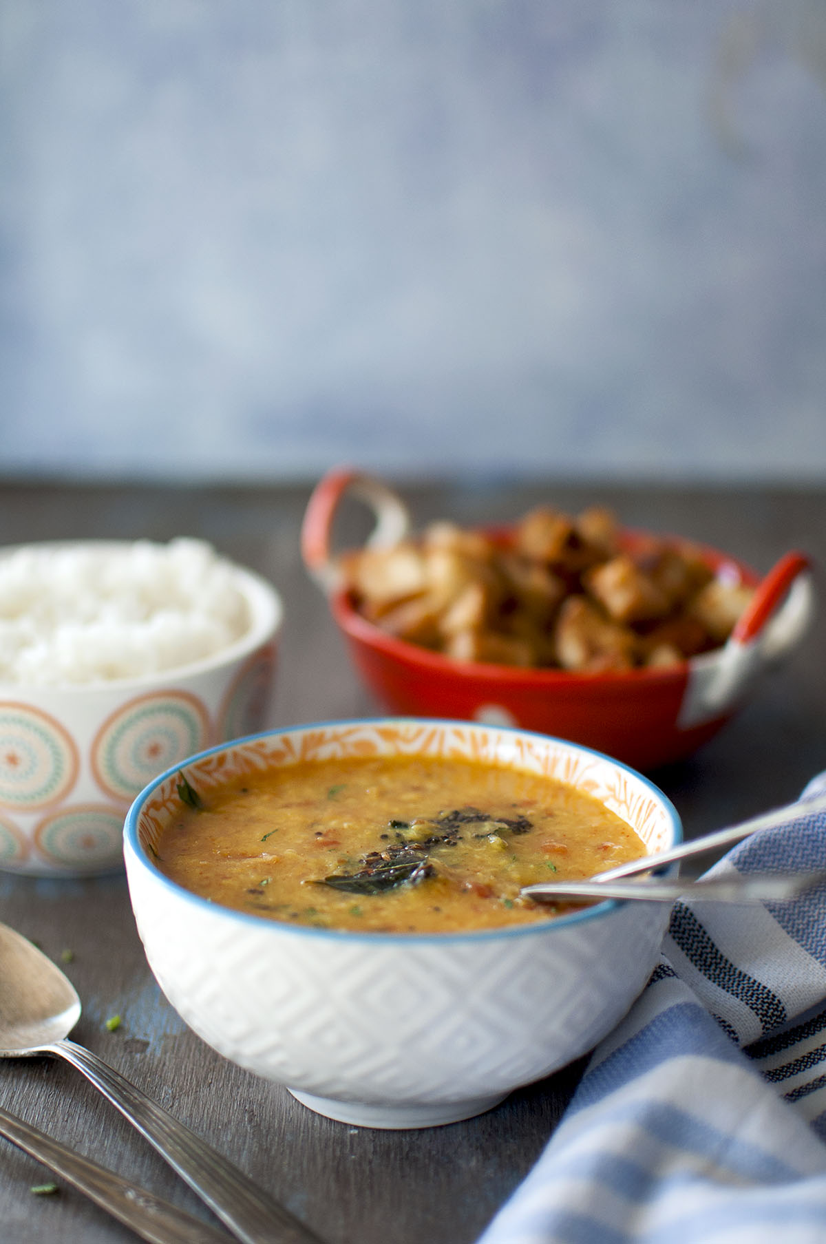 White bowl with pesara pappu charu.