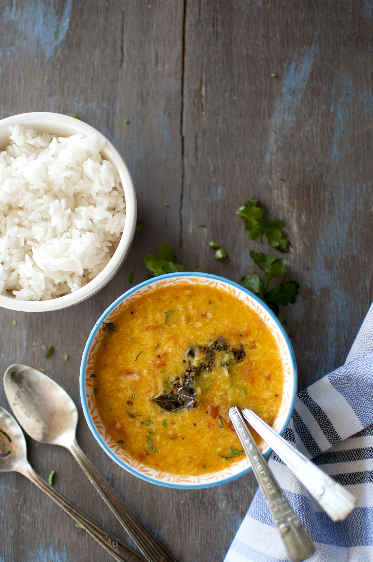 White bowl with pesara pappu charu.