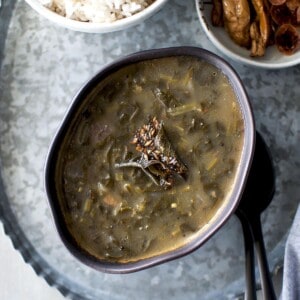 black bowl with palak pulusu