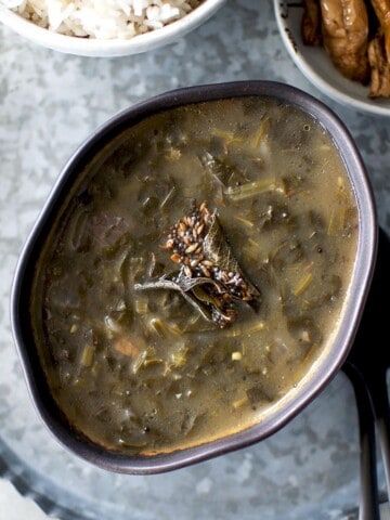 black bowl with palak pulusu