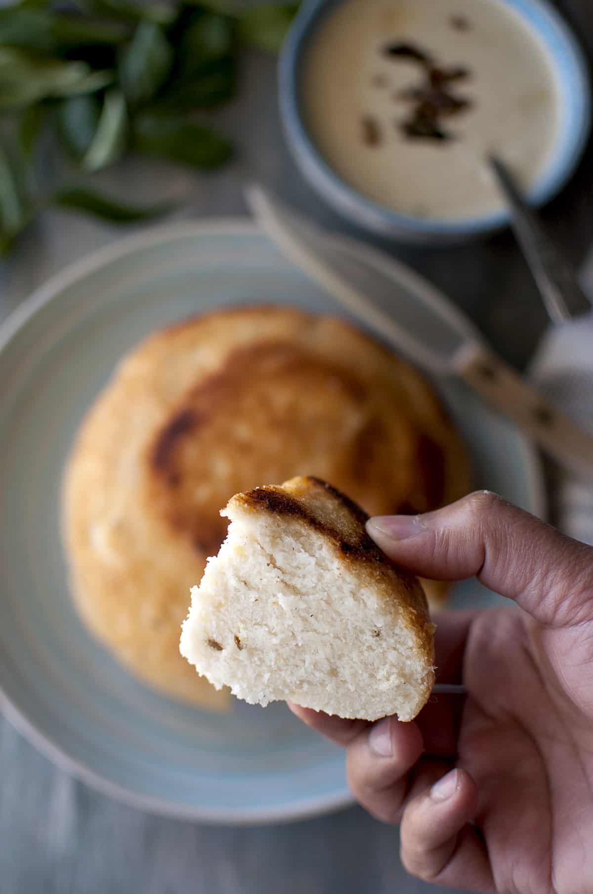 Hand holding a slice of Andhra dibba rotte