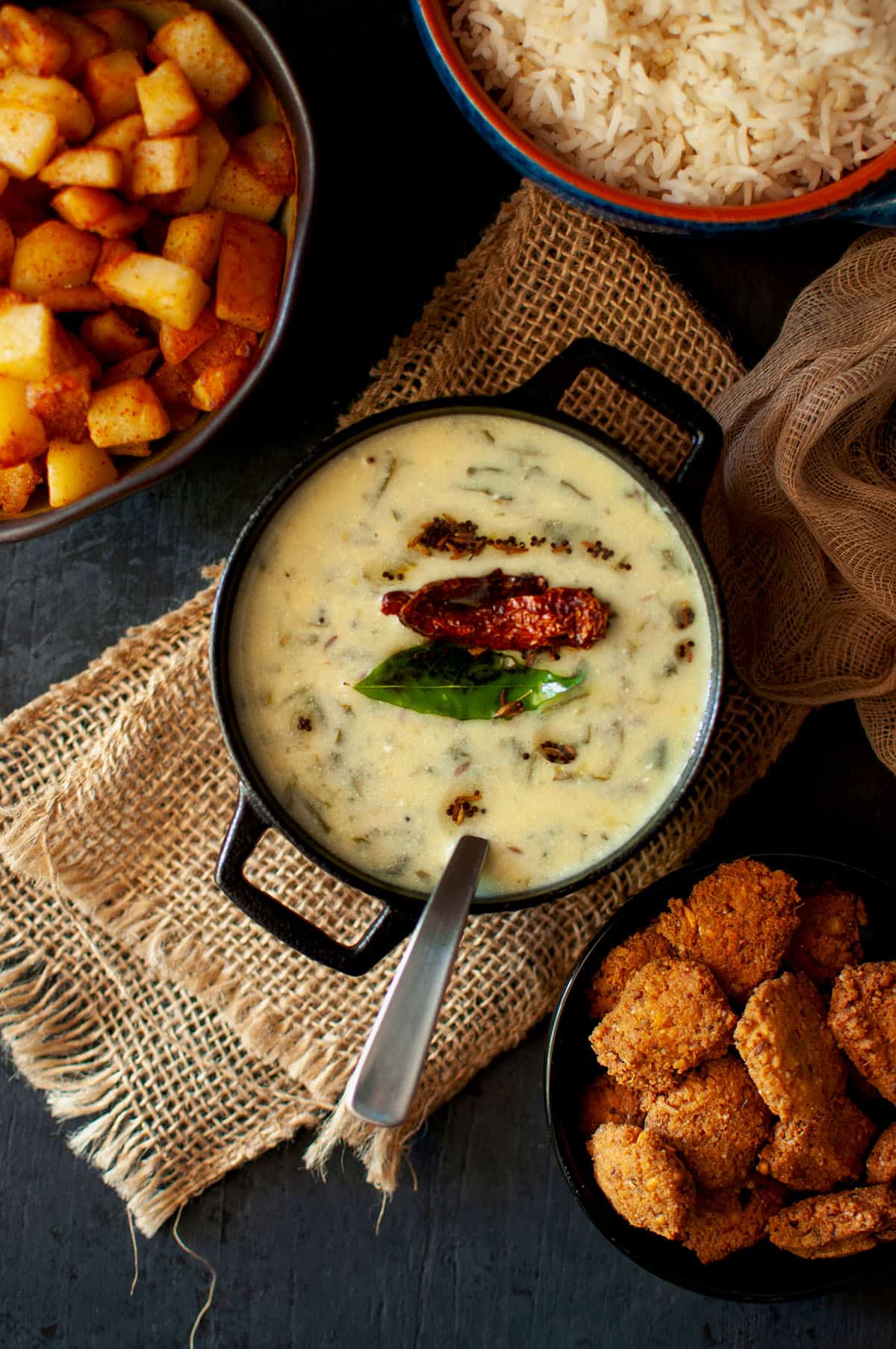 Black pan with vada majjiga pulusu.