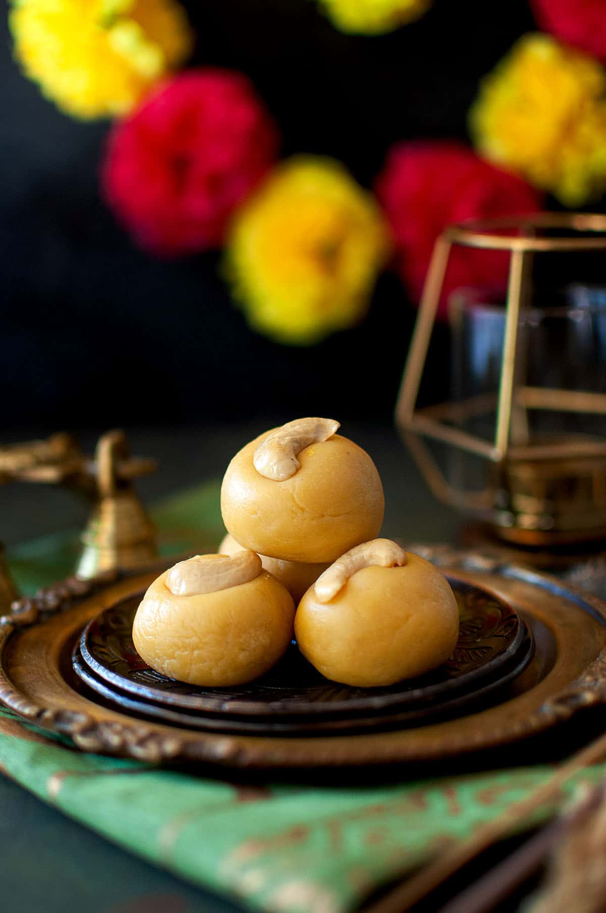 Brown plates with a stack of thokkudu ladoo.
