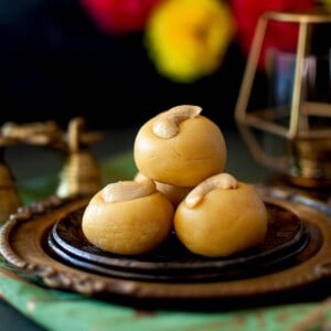 Brown plates with a stack of thokkudu ladoo.