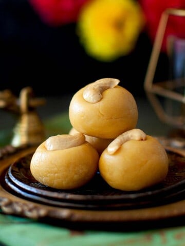 Brown plates with a stack of thokkudu ladoo.