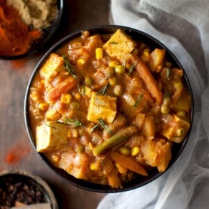 Black bowl with mixed vegetable tofu curry