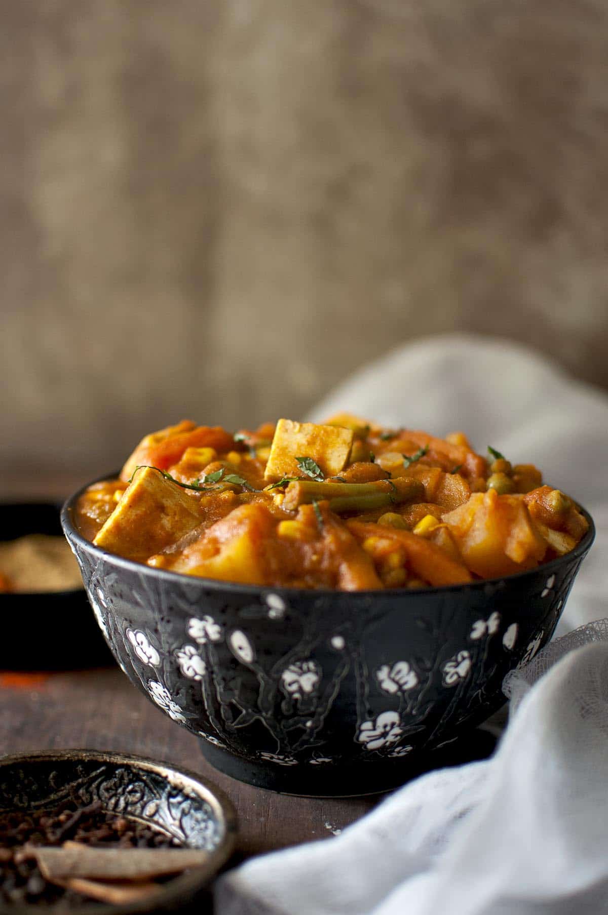 black bowl with spicy mixed vegetable curry