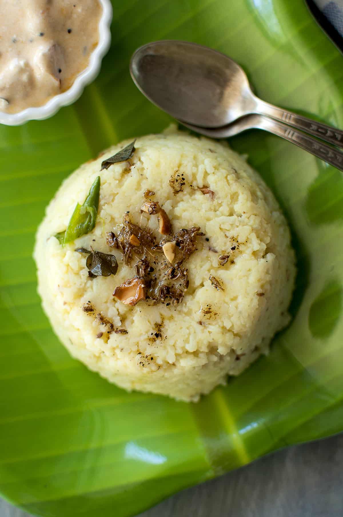 Green plate with pongal and spoons