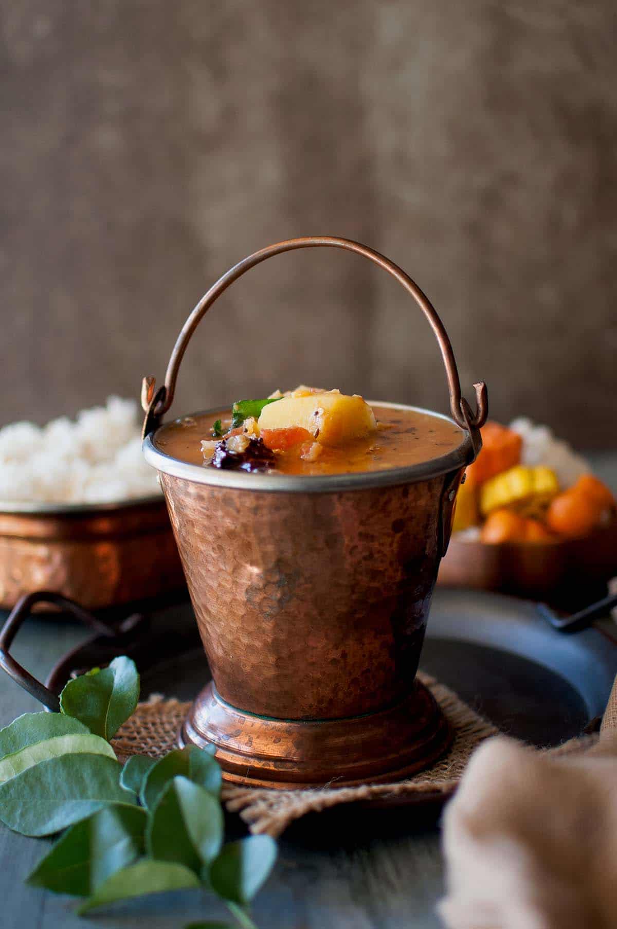 Brass bucket with South Indian lentil stew