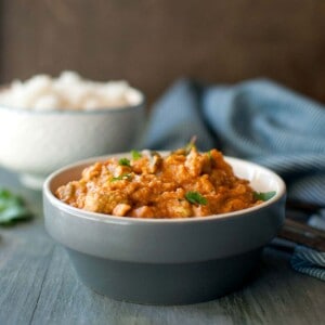 Gray bowl with kakarakaya masala curry.