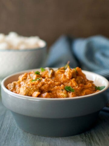 Gray bowl with kakarakaya masala curry.