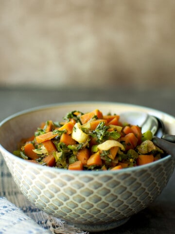 Bowl with greens and carrot curry.