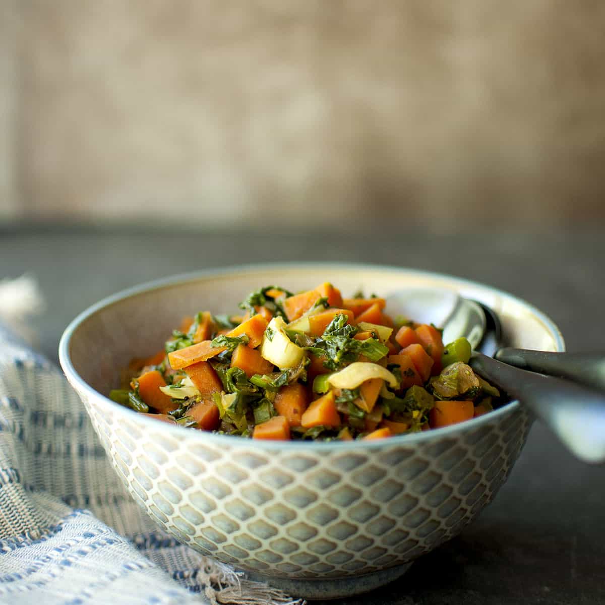 Bowl with Indian Bok choy and carrot curry.