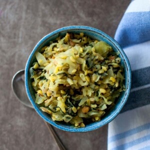 Blue bowl with spinach cabbage lentil curry.