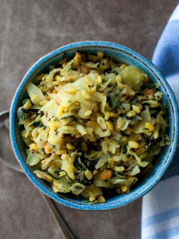 Blue bowl with spinach cabbage lentil curry.