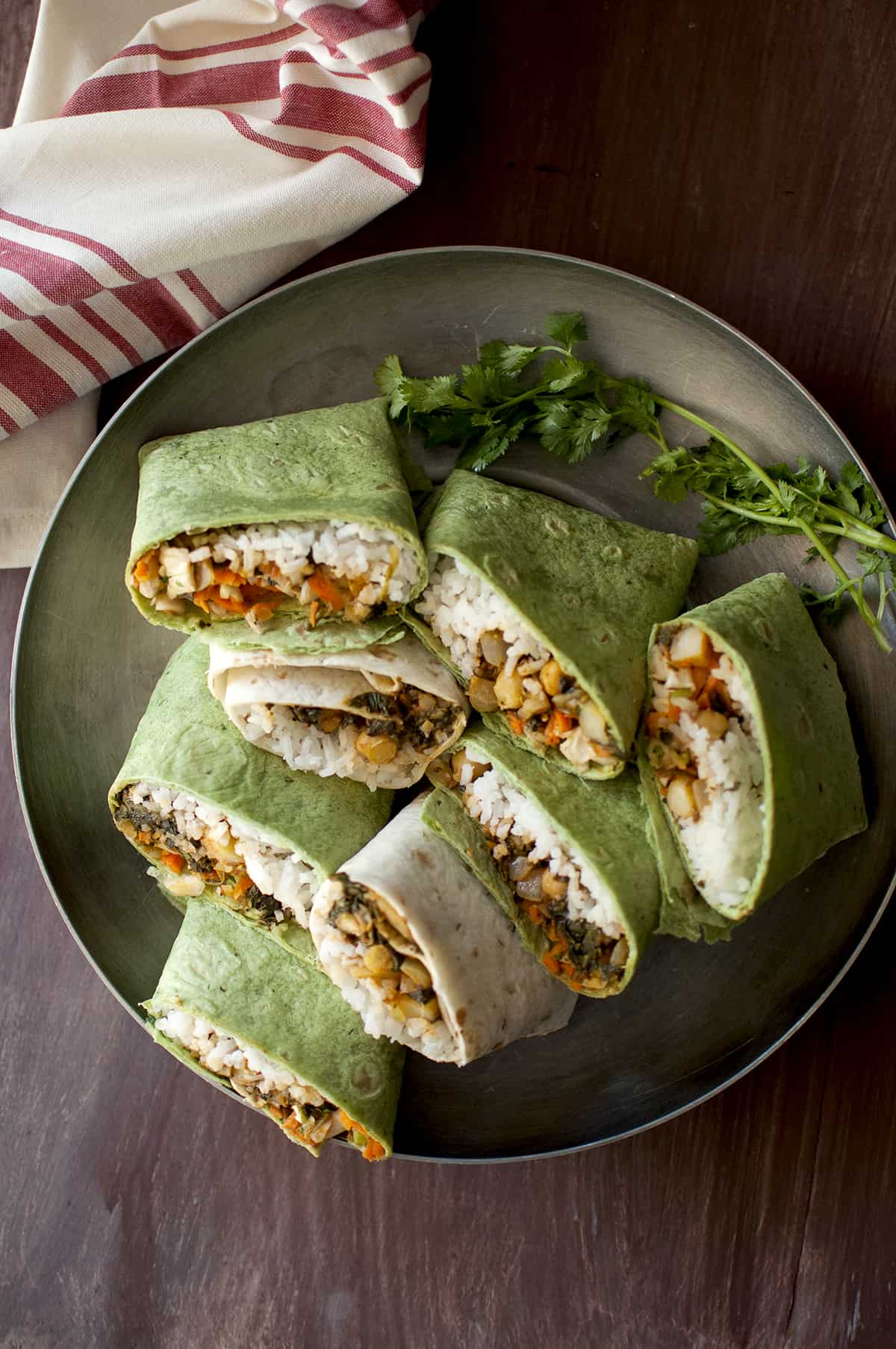 Steel tray with vegetarian wrap sandwiches.