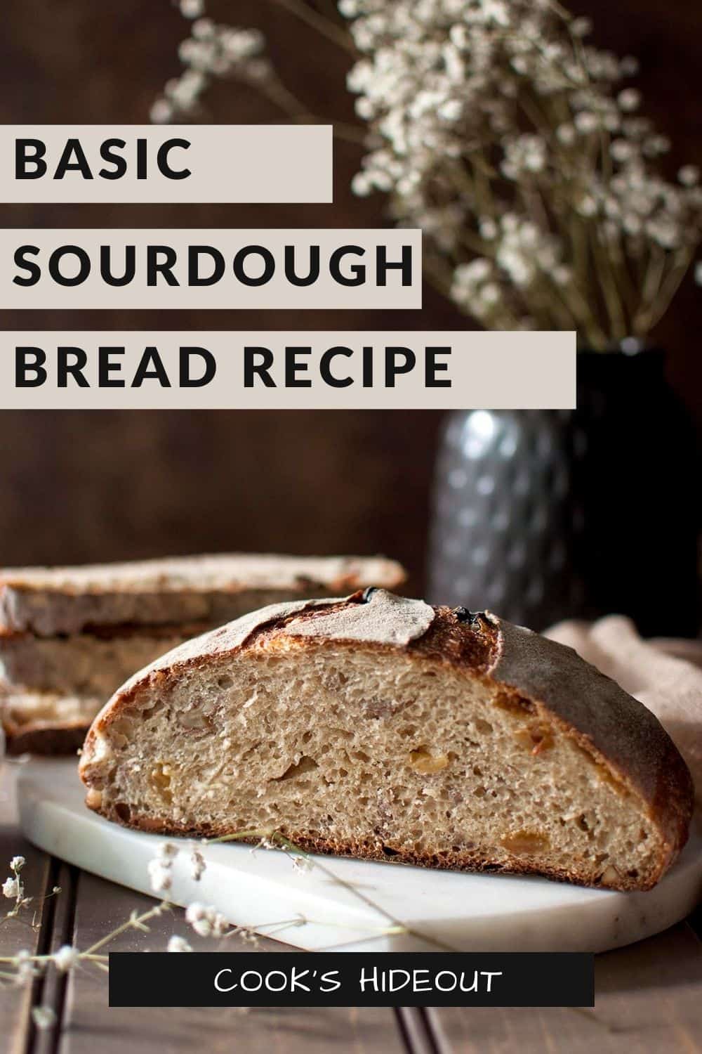 White chopping board with halved sourdough bread