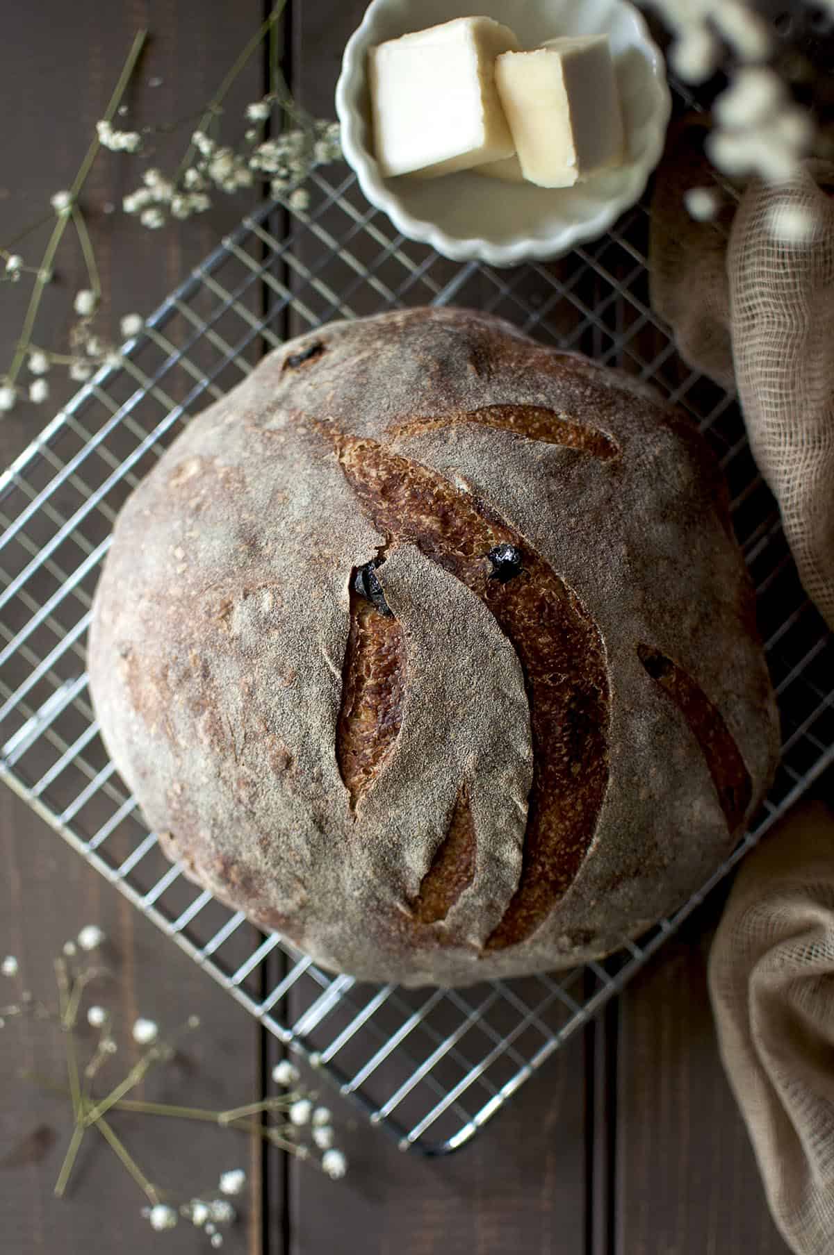 Top view of a sourdough boule on a wire rack