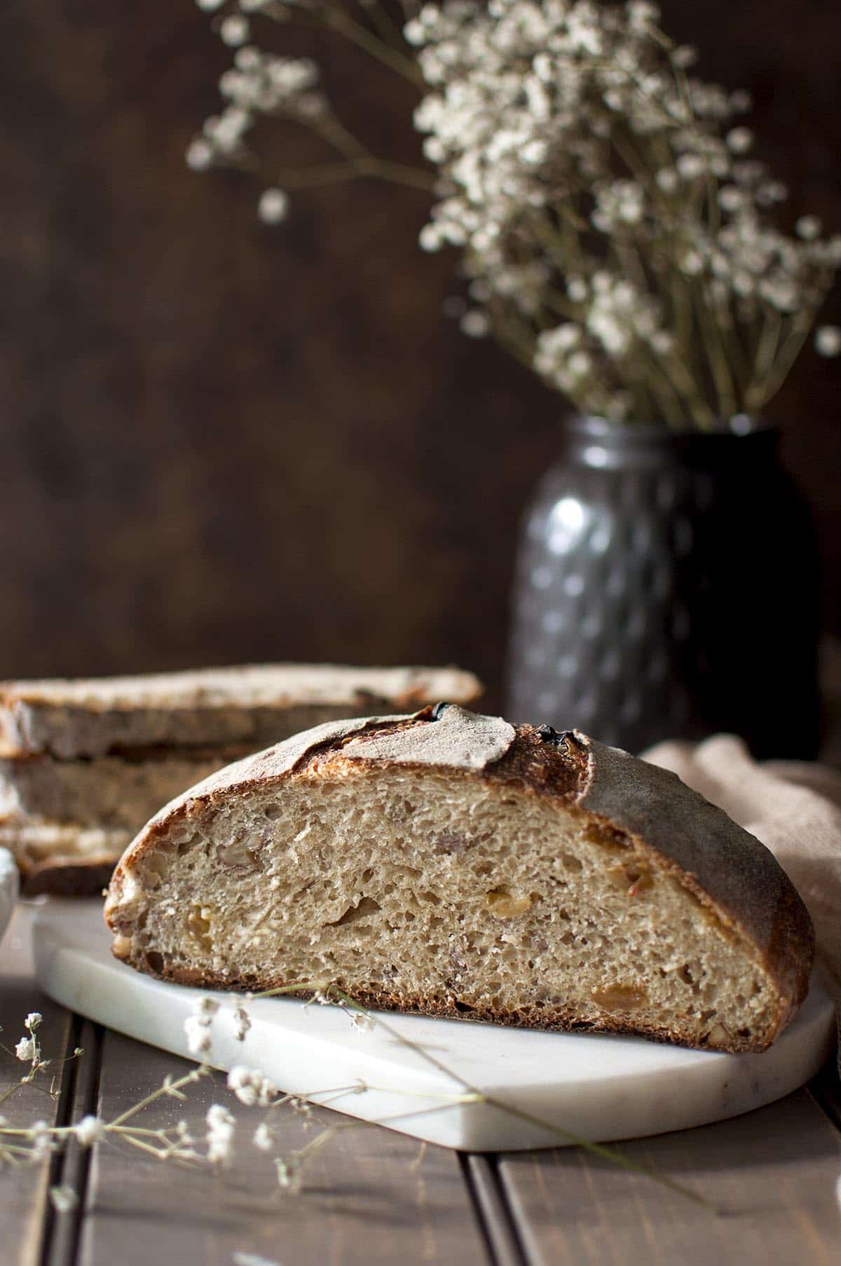 marble chopping board with half of a basic sourdough bread