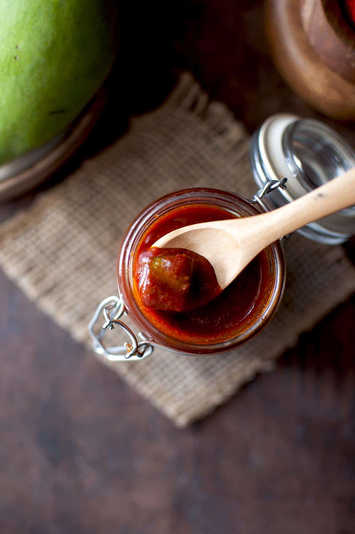 small wooden spoon in a glass jar with pickle