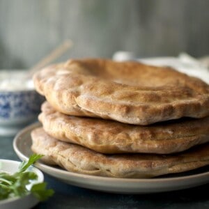 Grey plate with a stack of flatbread