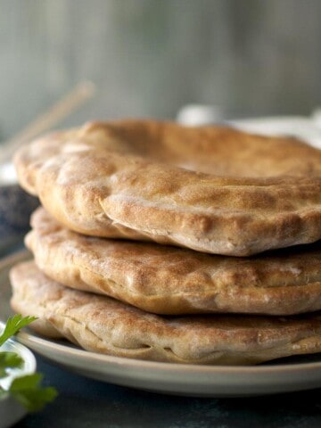 Grey plate with a stack of flatbread