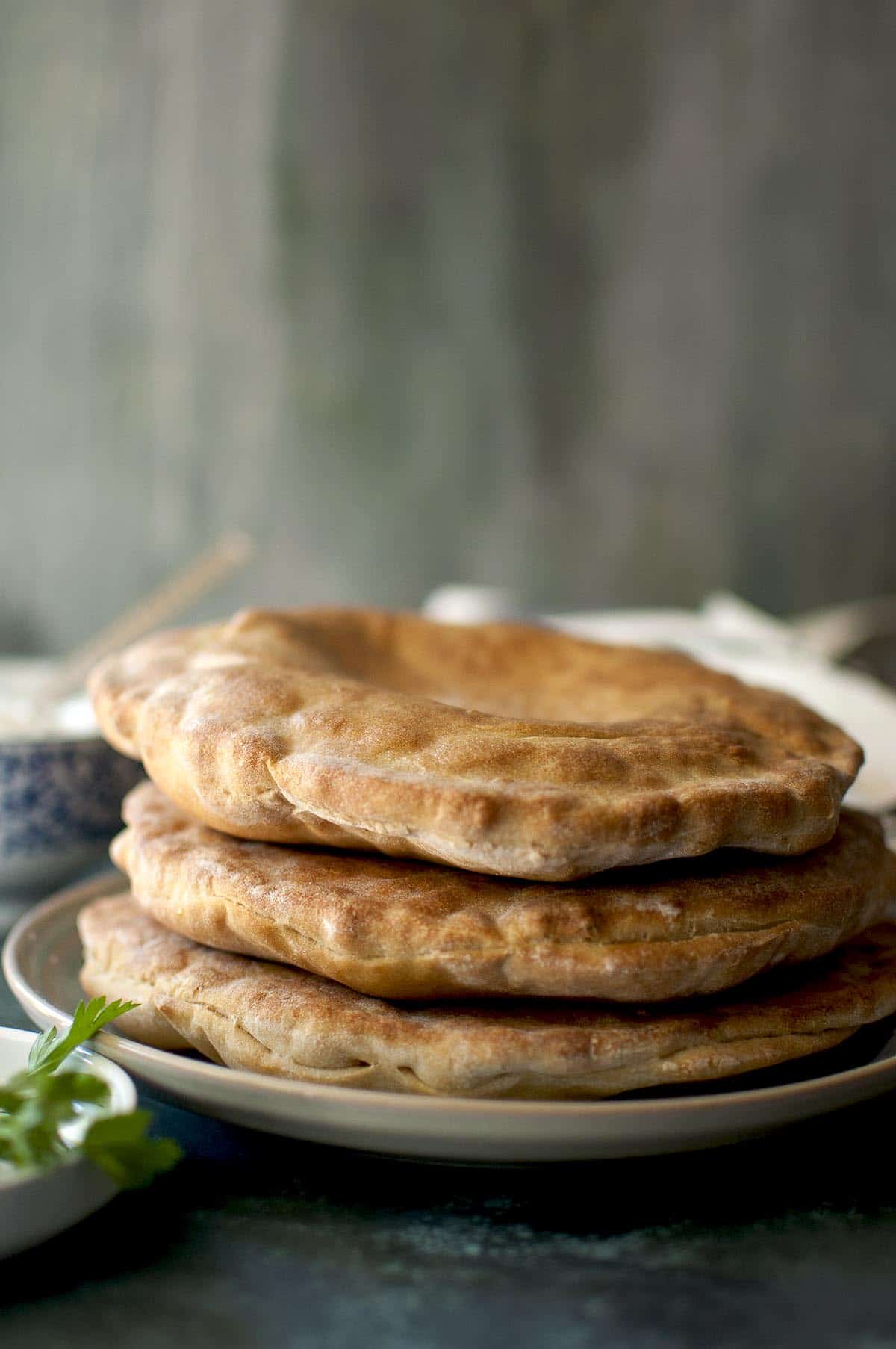 Grey plate with a stack of flatbread