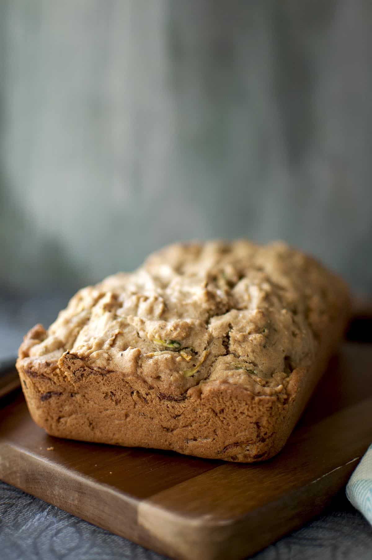 zucchini loaf placed on a chopped board