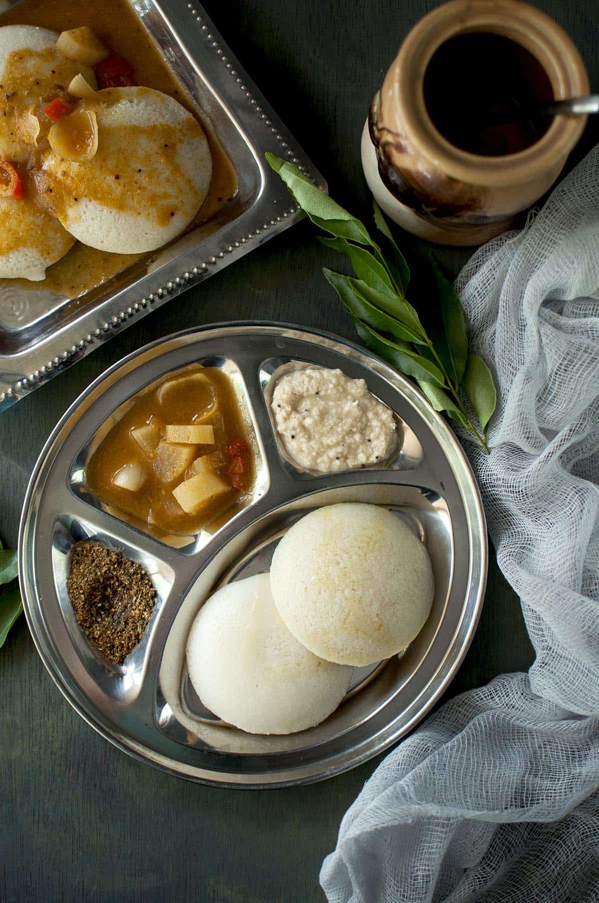 Soth Indian breakfast platter with steamed rice cakes, chutney and sambar