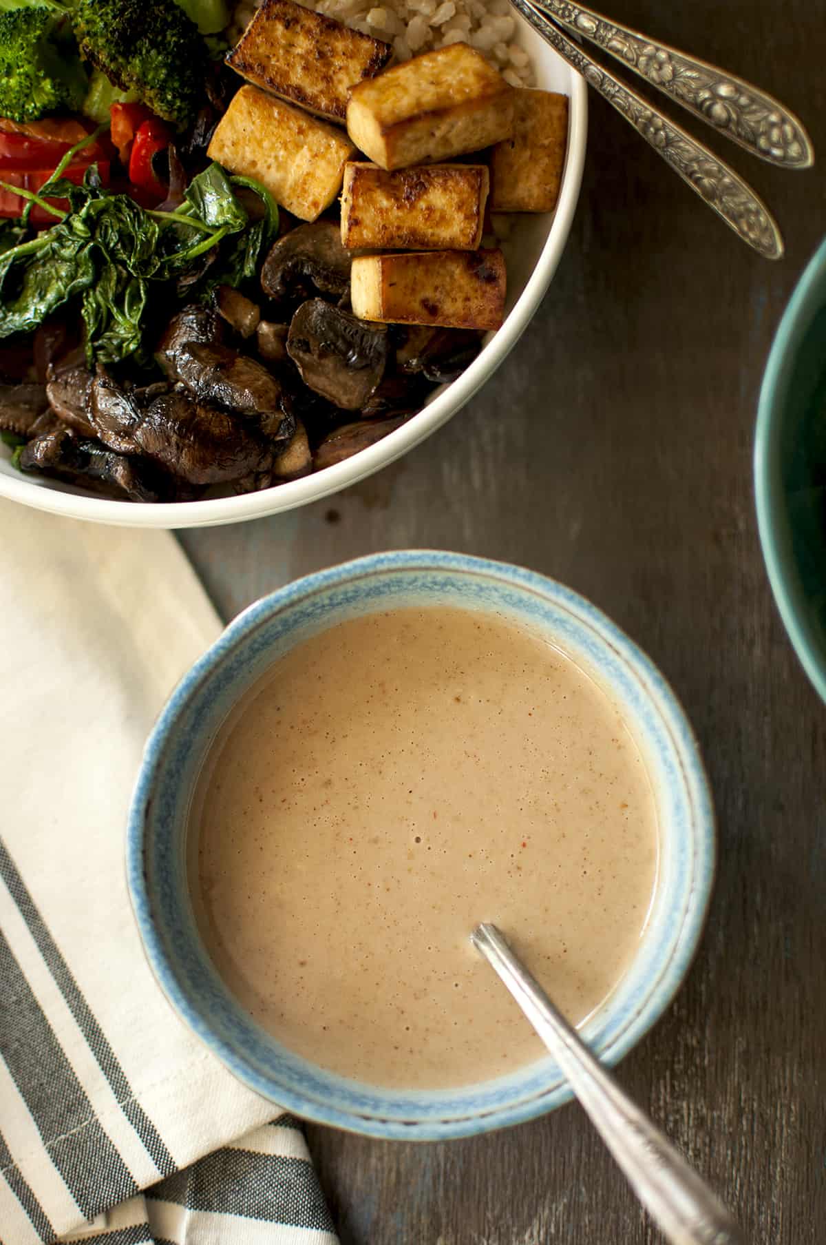 Blue bowl with creamy tahini sauce.