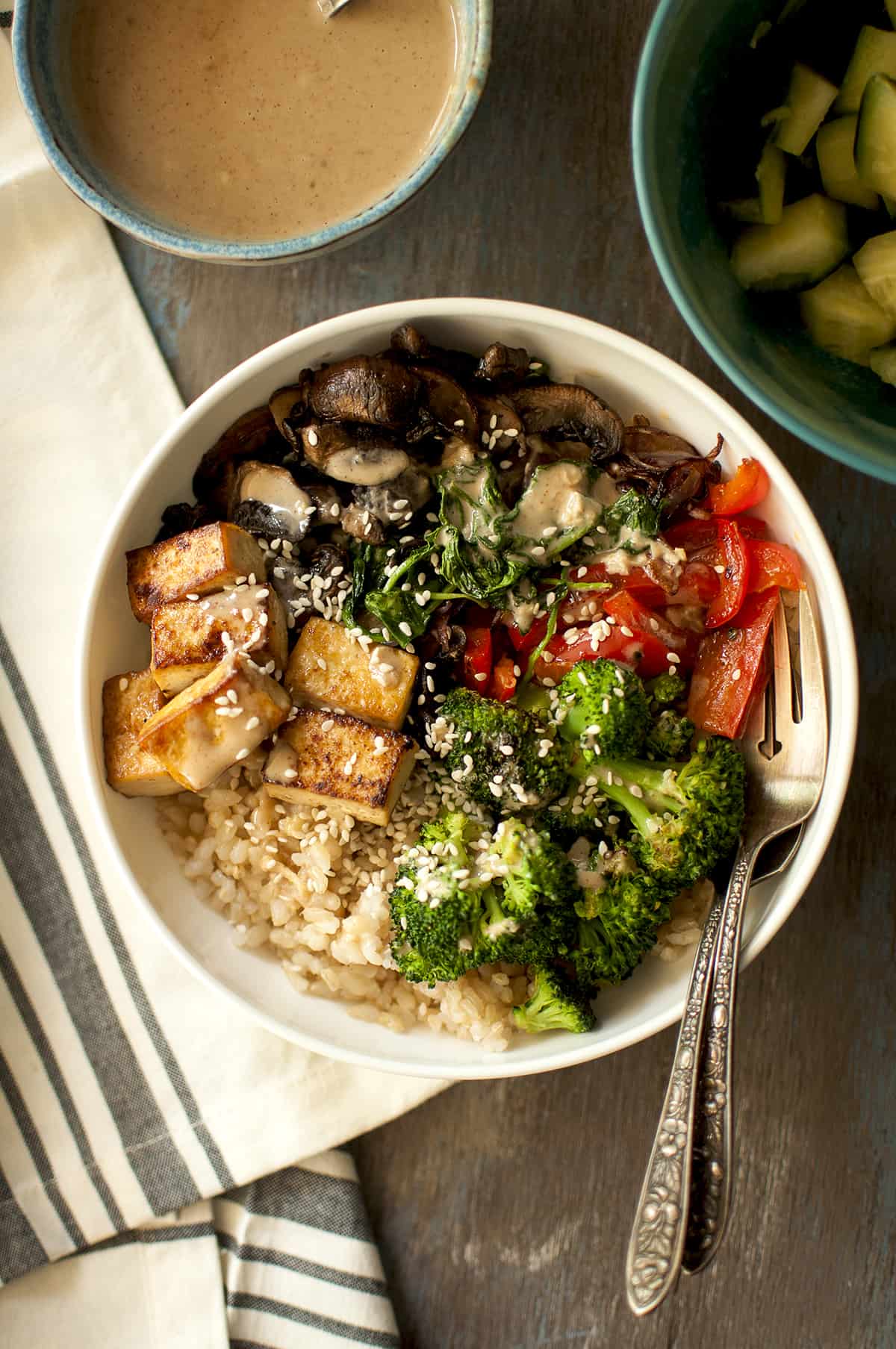 White bowl with brown rice and veggies.