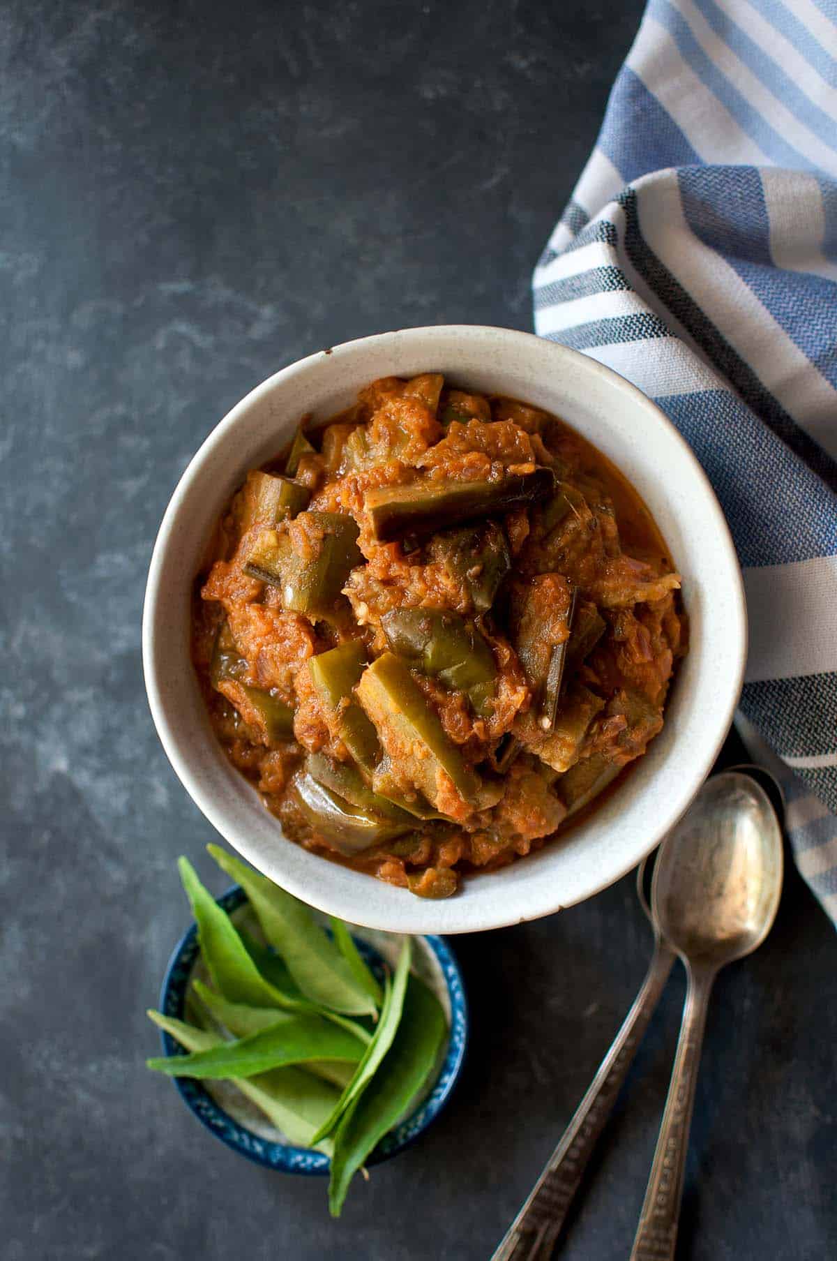 White bowl with brinjal onion curry