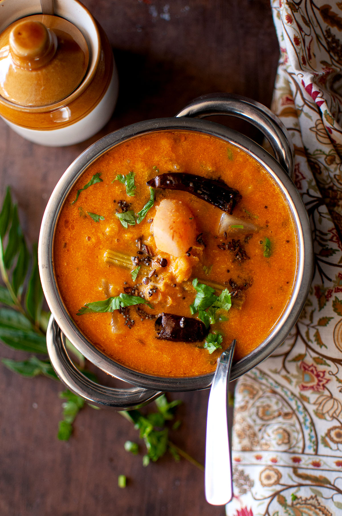 Top view of a steel bowl with instant pot masoor dal sambar.