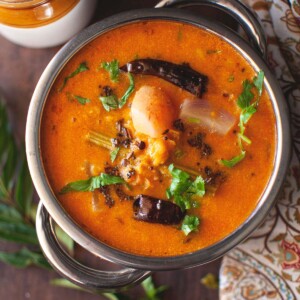 Top view of a steel bowl with masoor dal sambar.