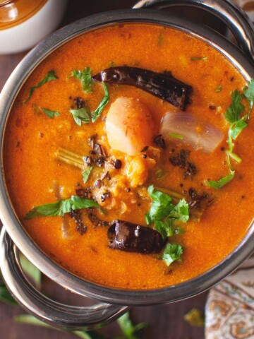 Top view of a steel bowl with masoor dal sambar.