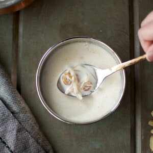 Hand holding a spoon with seviyan kheer