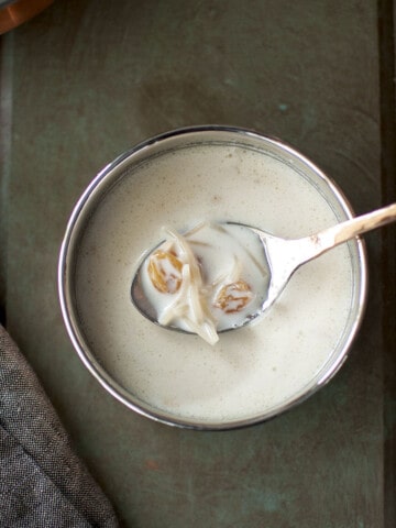 Hand holding a spoon with seviyan kheer