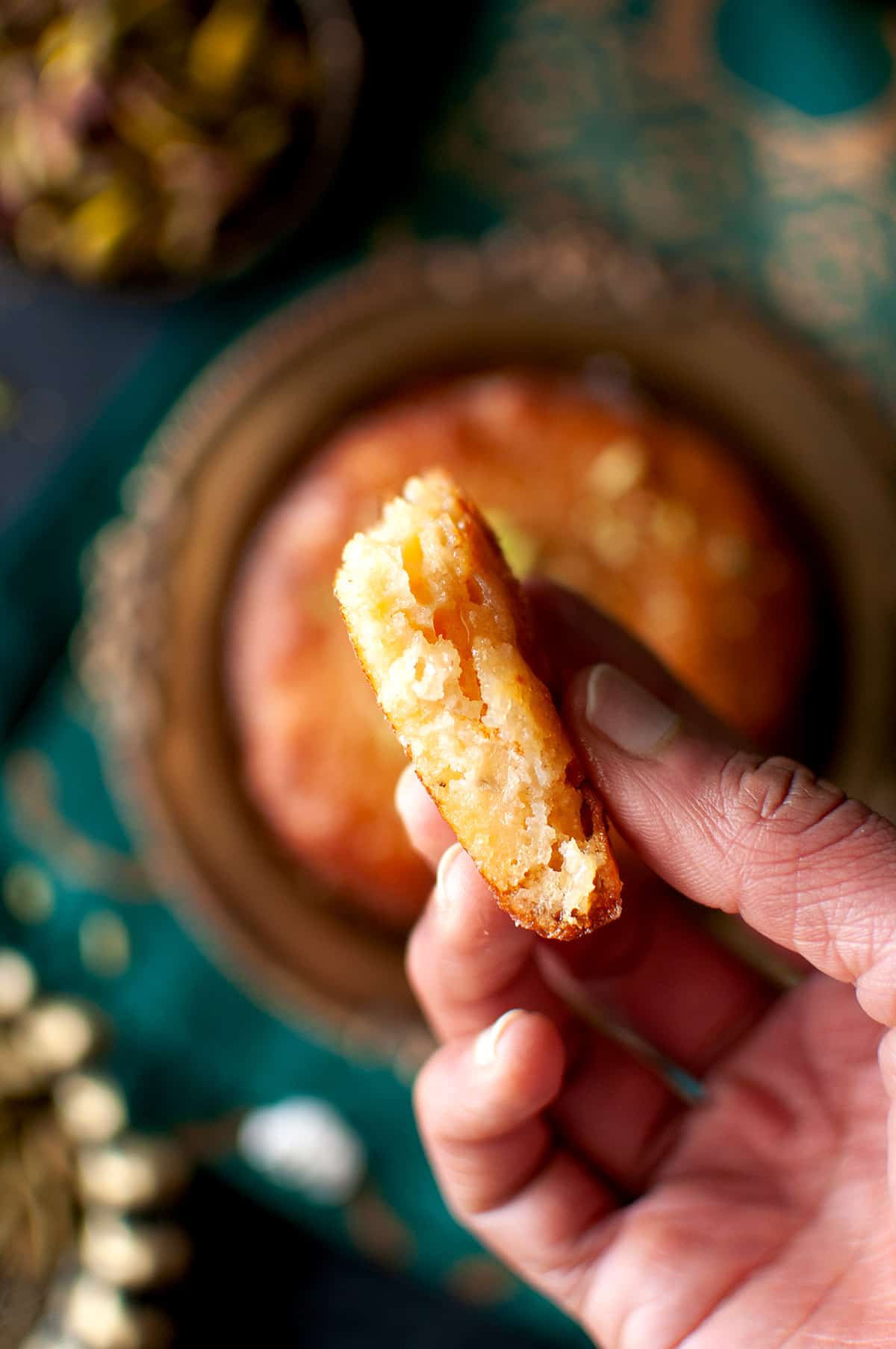 Hand holding a piece of pancake.