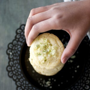 Hand holding a lime sugar cookie