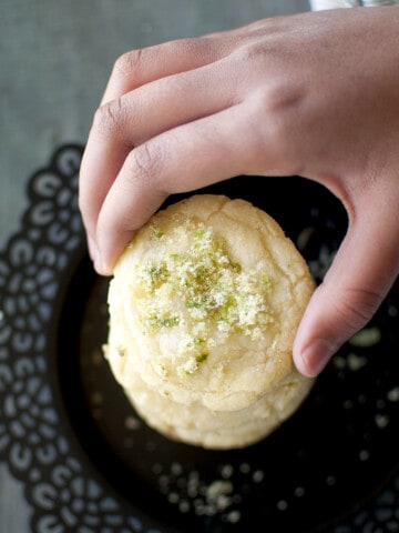 Hand holding a lime sugar cookie