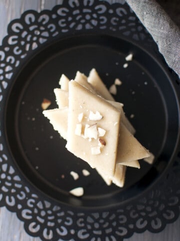 Black plate with a stack of almond fudge