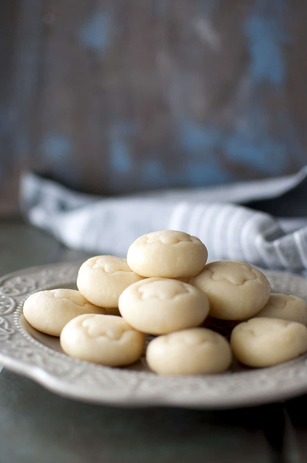 Grey plate with a stack of doodh peda