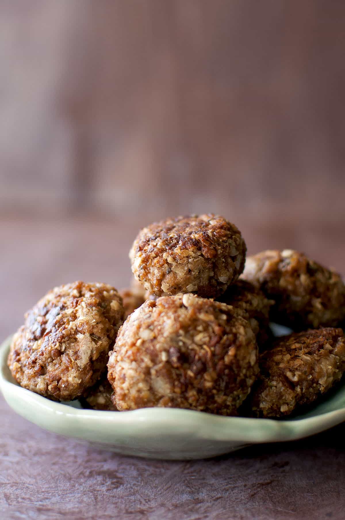 Green plate with a stack of meatballs