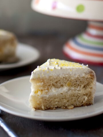 White plate with a slice of pineapple cool cake