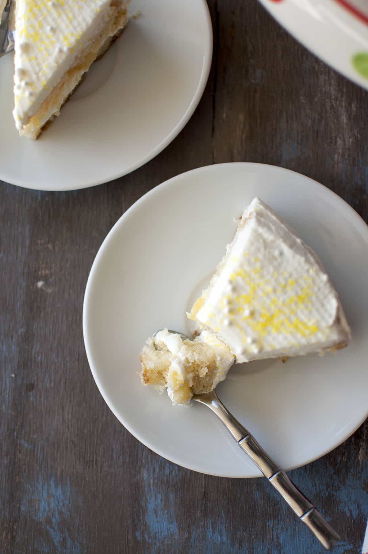 White plate with a slice of cake and a fork with a piece 