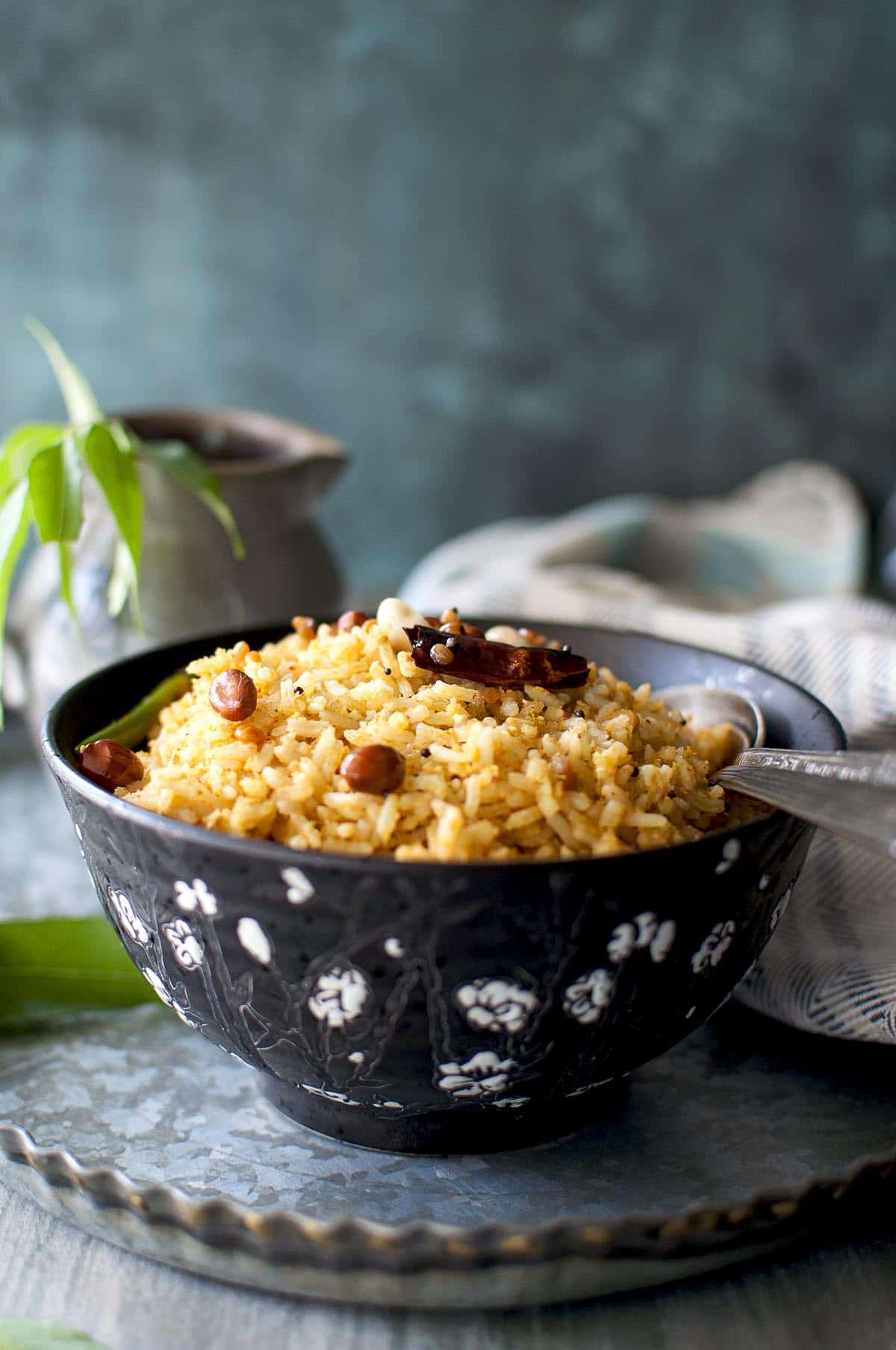 black bowl with mango rice topped with roasted peanuts