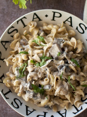 White bowl with mushroom pasta